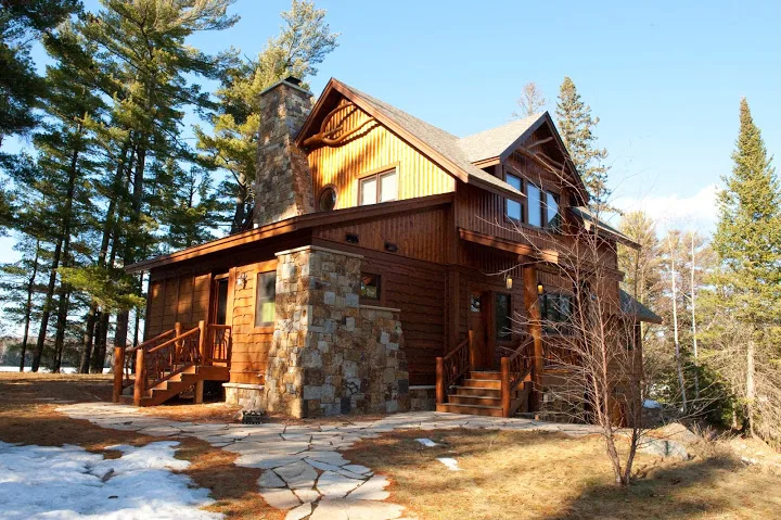 Keenan gallery photo of a log and stone home among trees