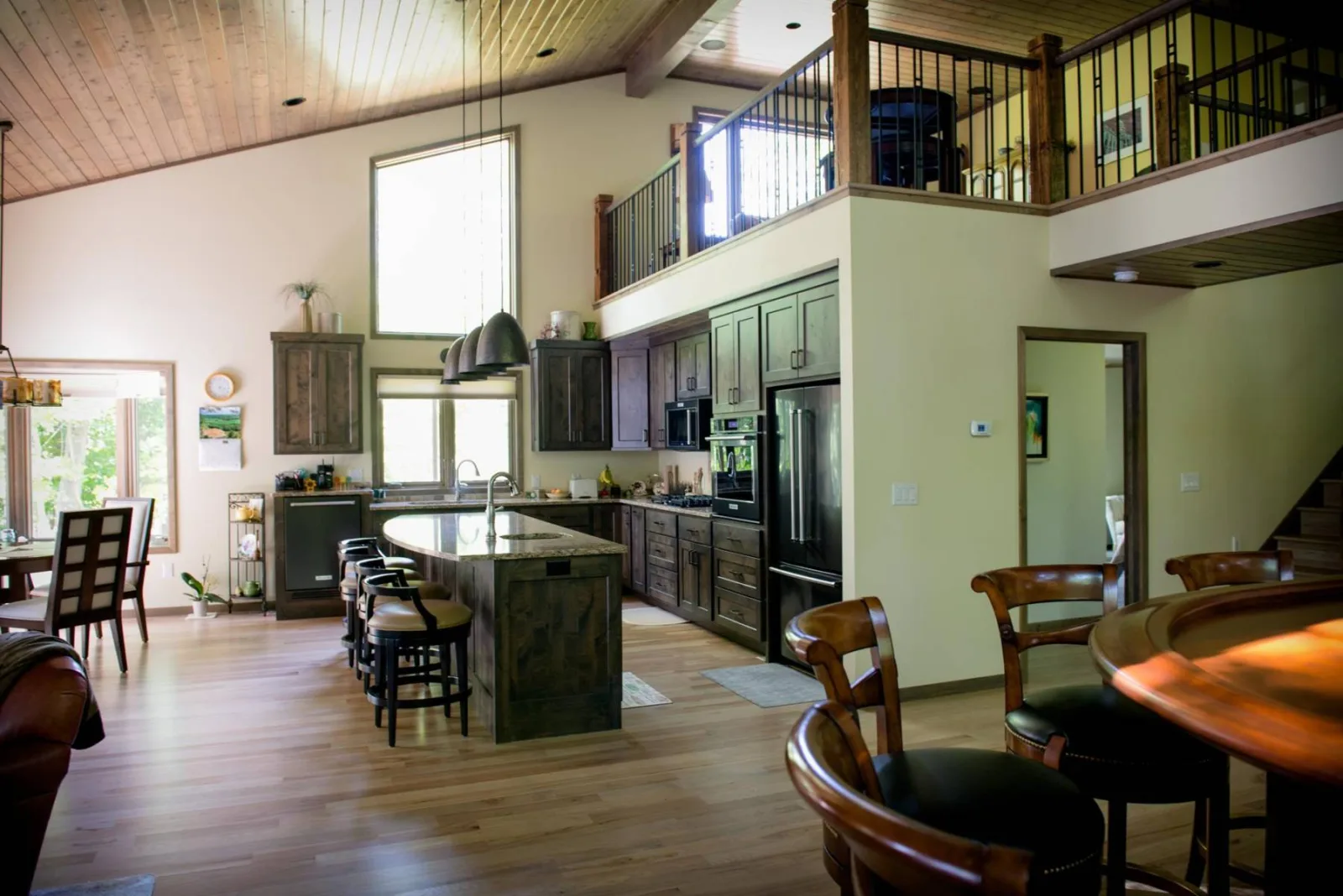 Open kitchen and living space beneath a high timber-trimmed ceiling, from Keenan's gallery