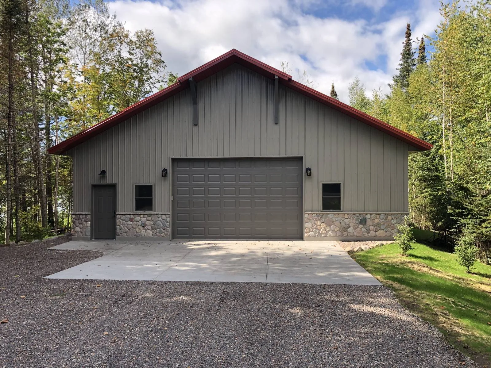 Freestanding gray shop with a red roof and large overhead door, from Keenan's gallery